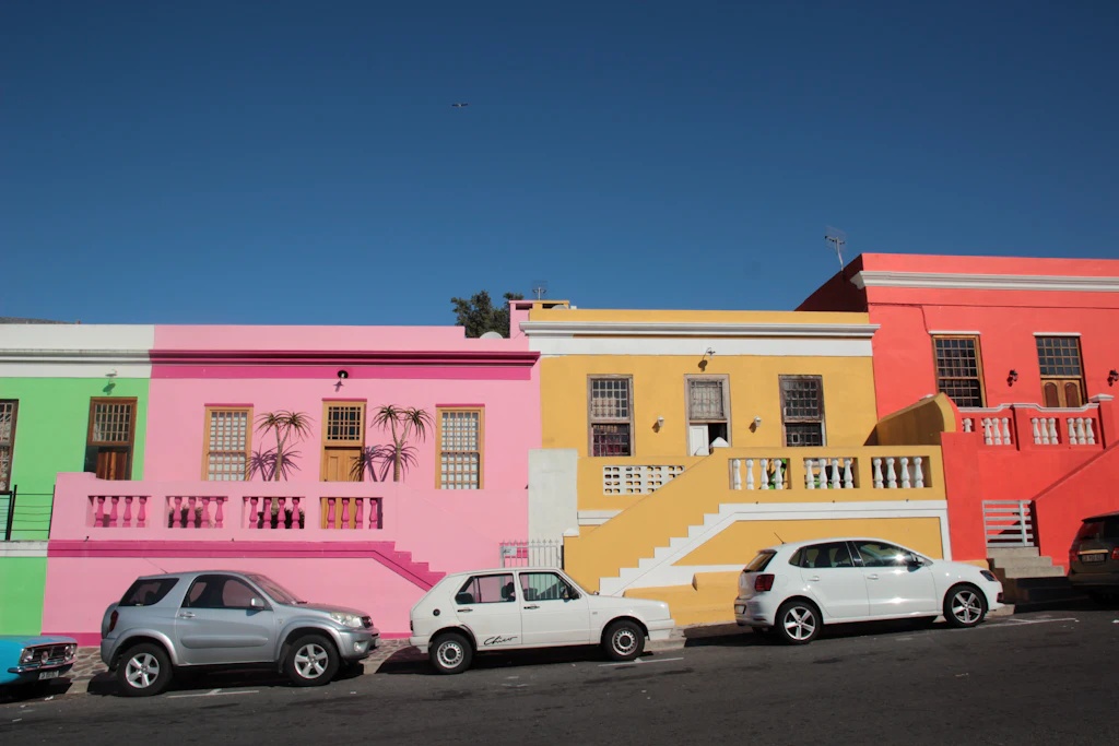 Pink, yellow and blue Bo-Kaap houses under a blue sky
